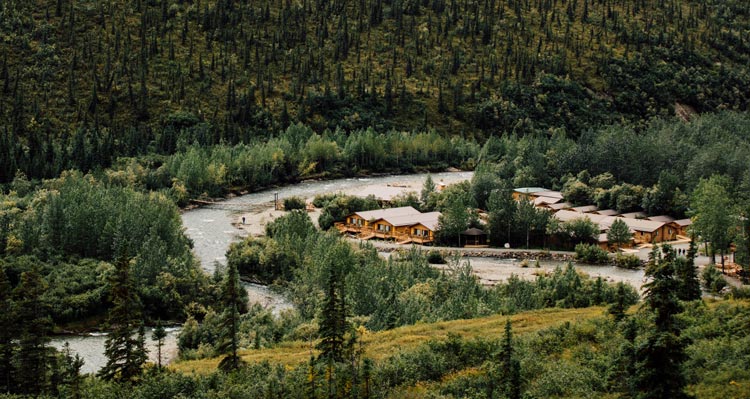 An aerial view of the Denali Backcountry Lodge next to a river.
