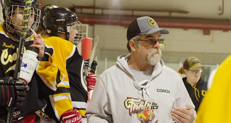 Martin Brewer coaches a team of hockey players.