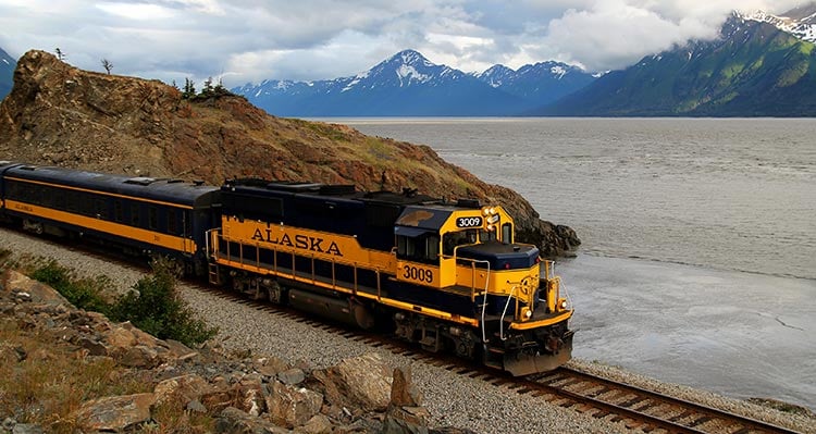 An Alaska Railroad train travels along near the water