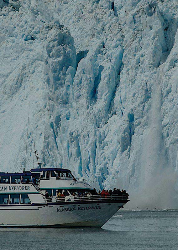 A sightseeing boat next to a glacier calving