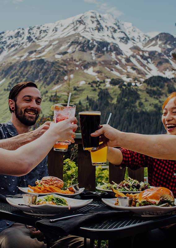 A group of friends raise their glasses in cheers