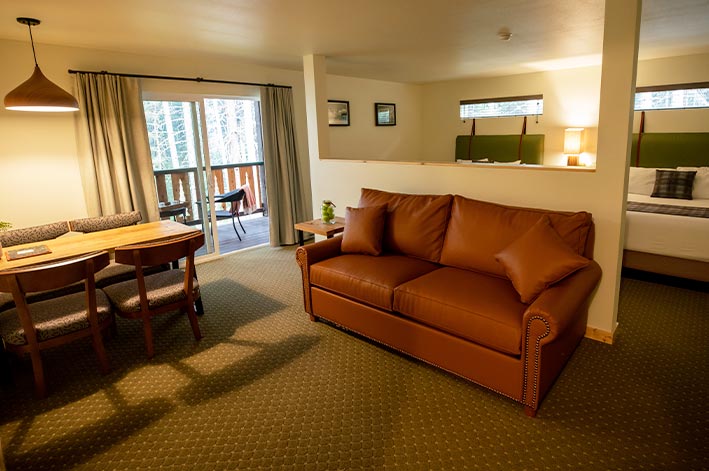 A lounge and dining area in a hotel suite.