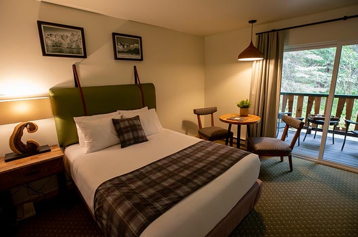 Bed in a hotel room with seating area to the side