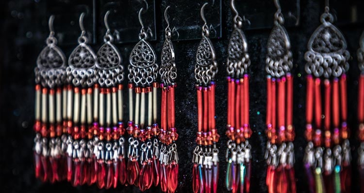 Nine porcupine quill earings hang in a display