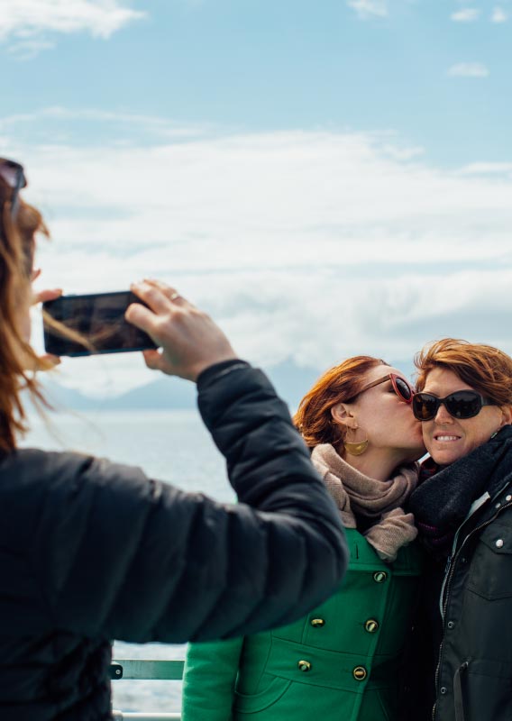 Two people have their photo taken on a boat deck.