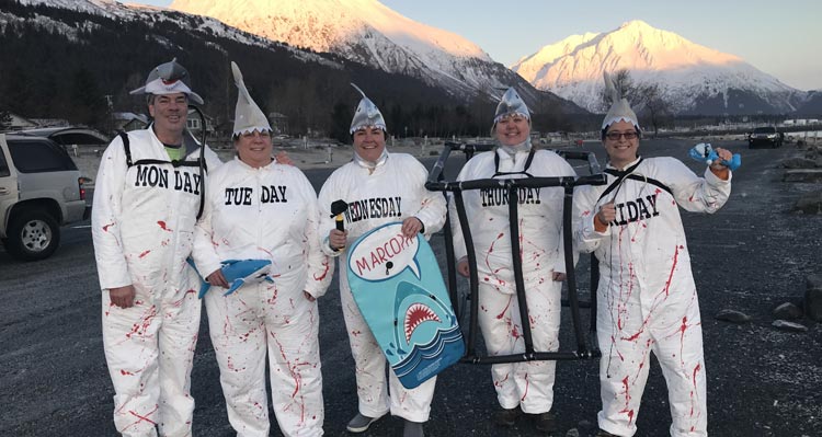 A group of friends, dressed as sharks, ready for a polar plunge.