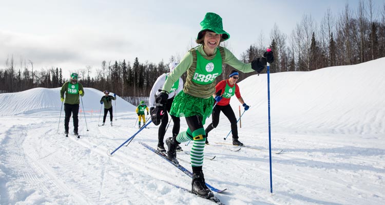 A group of skiers make their way on a cross-country race.