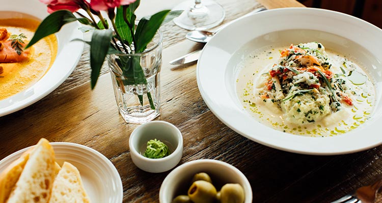 A bowl of soup set on a dining table