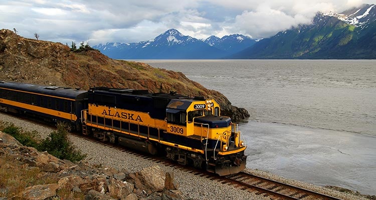 An Alaska Railroad train travels along the water