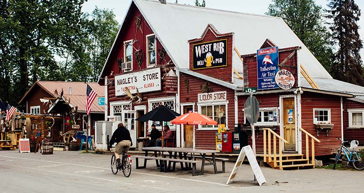 A wooden building on a small street.