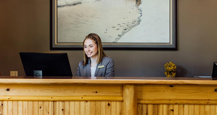 A hotel worker at a desk.