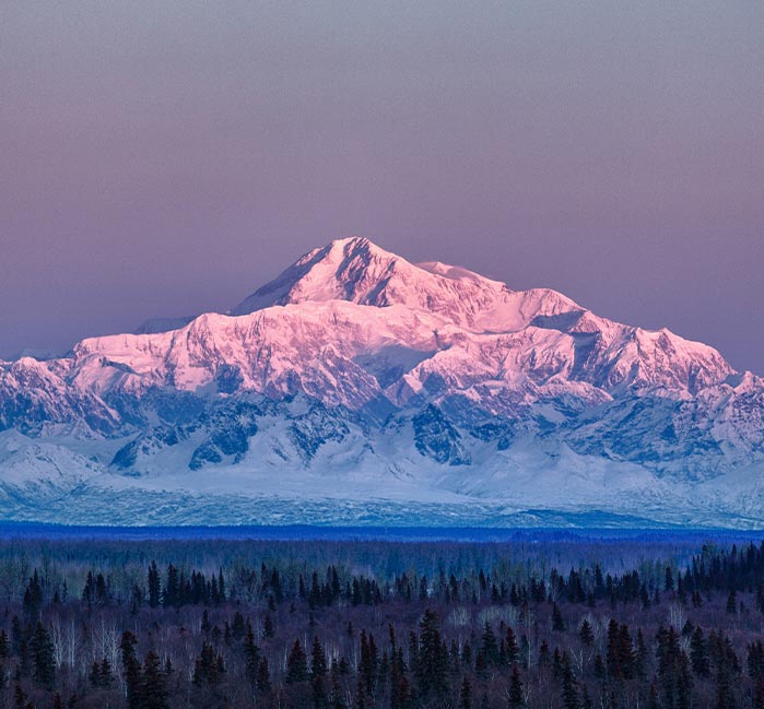 A view of a tall snow-covered mountain.