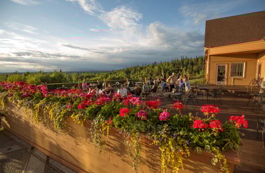 People dining on the patio at Talkeetna Alaskan Lodge