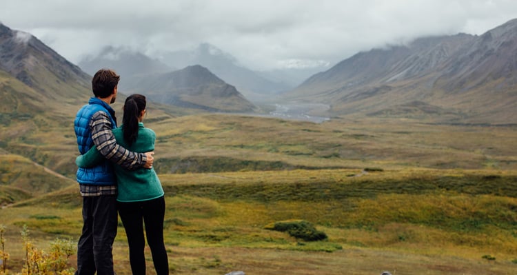 A couple looking out to the mountain view at Denali Backcountry Lodge
