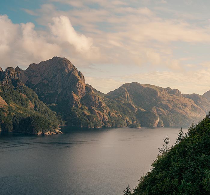 Landscape photo of water between two rocky ranges during the day.