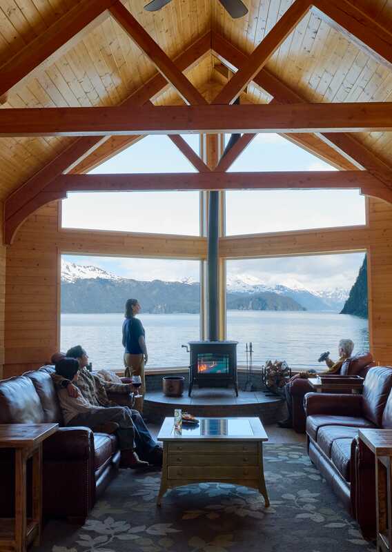 A family sitting by the window in the lounge at the Kenai Fjords Wilderness Lodge.