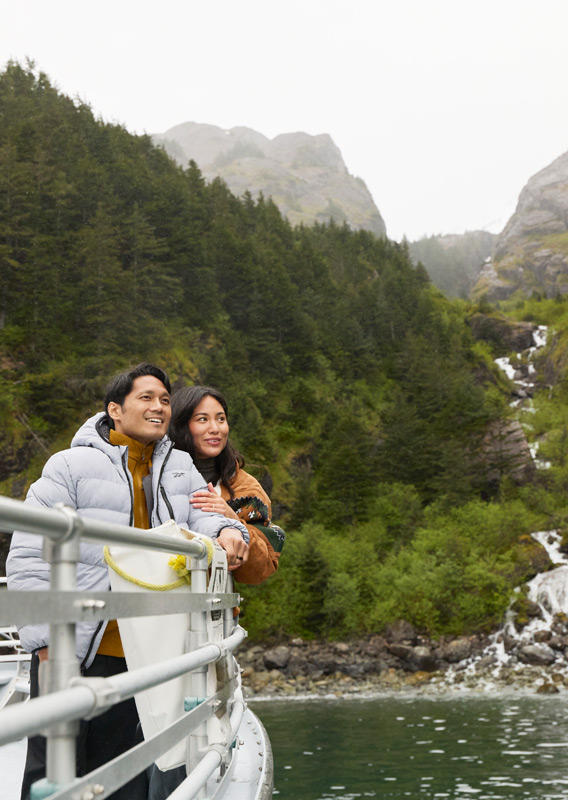 A couple taking in the view from the bow of a KFT boat