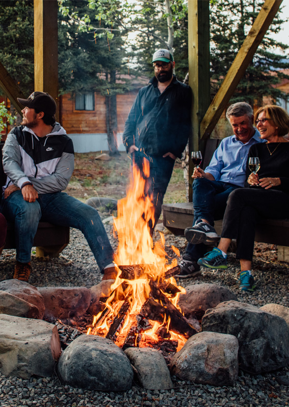 A group of people sitting around a campfire