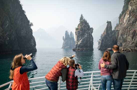 A group of tourists taking photos and looking at the view at Spire Cove in Resurrection Bay.