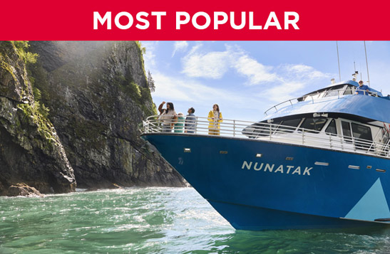 A boat moves past a large glacier