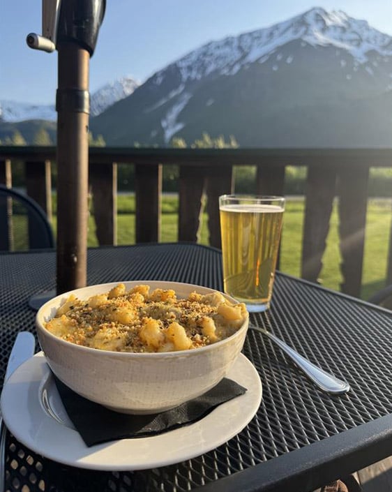 Lobster Mac & Cheese and a beer set on a table at Resurrection Roadhouse