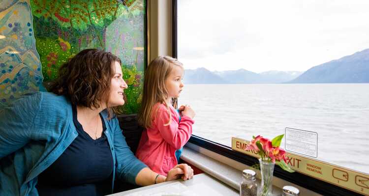 Parent and child dining and sightseeing on boat tour