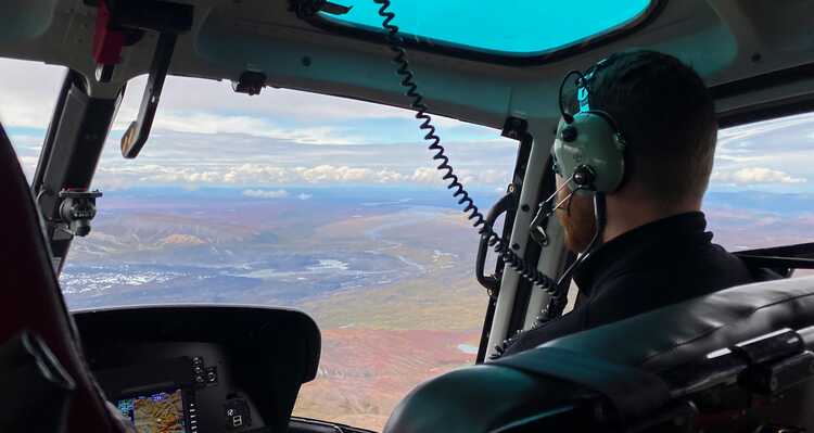 A helicopter passenger taking in the view