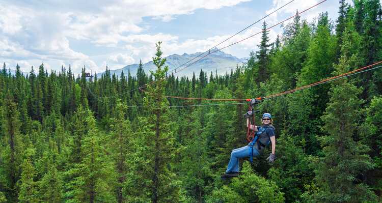 A person posing on the Denali Zipline