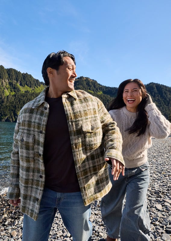 A couple walking along the beach in Alaska