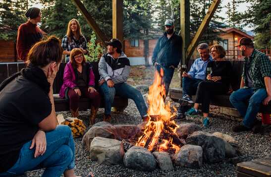A group of people sitting around a campfire