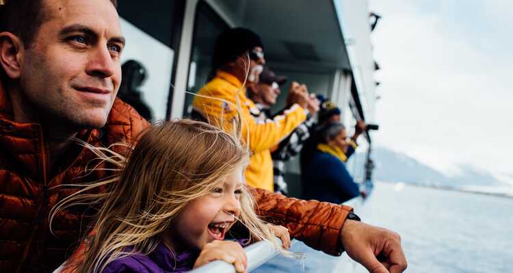 Parent and child sightseeing on a boat tour