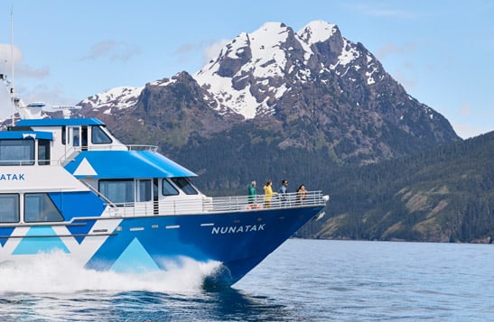 A group of sightseers taking in the view from the bow of a KFT boat