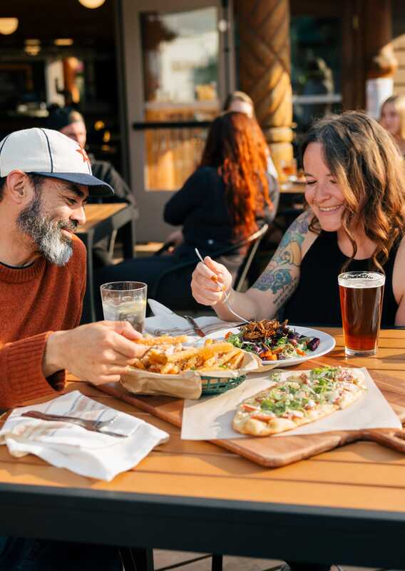 A couple dining on an outdoor patio at a restaurant in Alaska